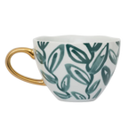 Goedemorgen kopje cappuccino/theebladeren, water